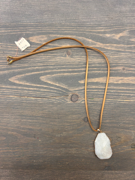 White gemstone necklace on leather chain